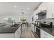 Bright kitchen with granite countertops, modern appliances, white cabinetry, and open view to the dining area at 8812 Parsons Hill Blvd, Wesley Chapel, FL 33545