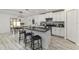 Modern kitchen featuring white cabinets, granite countertops, stainless steel appliances, and an eat-in island at 8812 Parsons Hill Blvd, Wesley Chapel, FL 33545