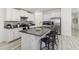 Modern kitchen with white cabinetry, a center island with seating, and stainless steel appliances at 8812 Parsons Hill Blvd, Wesley Chapel, FL 33545