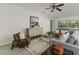 Bright living room with ample seating, neutral-colored walls, and large windows for natural light at 8812 Parsons Hill Blvd, Wesley Chapel, FL 33545