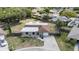 Aerial view of a home with a long driveway, stone exterior, and well-manicured landscaping at 8918 Carmen Ln, Port Richey, FL 34668