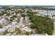 Aerial view of a neighborhood highlighting lush trees, and a home with a pool at 8918 Carmen Ln, Port Richey, FL 34668