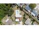 Overhead view of a private backyard featuring a refreshing pool surrounded by a fenced-in yard and mature trees at 8918 Carmen Ln, Port Richey, FL 34668