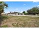 Spacious backyard with a view of the home's exterior and a pool at 8918 Carmen Ln, Port Richey, FL 34668