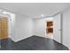 An open finished basement with tile flooring and access to the kitchen at 8918 Carmen Ln, Port Richey, FL 34668