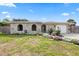 Attractive home with a stone exterior, a flower-lined walkway, and a well-kept lawn at 8918 Carmen Ln, Port Richey, FL 34668