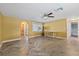 Spacious living room with herringbone floors, large windows, and a ceiling fan creates a welcoming atmosphere at 8918 Carmen Ln, Port Richey, FL 34668