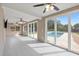 Bright living room with tile floors and large sliding glass doors overlooking the backyard pool at 8918 Carmen Ln, Port Richey, FL 34668