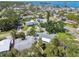 Expansive aerial view of waterfront homes with lush landscaping and stunning water views in a desirable neighborhood at 94 Nicholas Dr, Dunedin, FL 34698