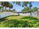 Manicured backyard with a well-maintained lawn and a privacy fence providing seclusion at 94 Nicholas Dr, Dunedin, FL 34698