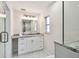 A view of the primary bath showcasing a granite vanity and a framed shower at 94 Nicholas Dr, Dunedin, FL 34698