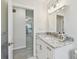 Bright bathroom featuring a granite vanity top, modern lighting, and tiled floors at 94 Nicholas Dr, Dunedin, FL 34698