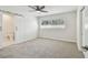 Bright bedroom with new carpet, ceiling fan and attached bath with sliding barn door at 94 Nicholas Dr, Dunedin, FL 34698
