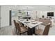 Elegant dining area open to the living room and kitchen, featuring a modern table and ample seating at 94 Nicholas Dr, Dunedin, FL 34698