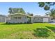 Charming one-story home with a well-manicured lawn, brick accents, and a freshly painted exterior at 94 Nicholas Dr, Dunedin, FL 34698