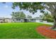 Charming single-story home with a well-manicured lawn, mature trees, and an inviting entrance at 94 Nicholas Dr, Dunedin, FL 34698