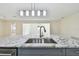 Granite island sink with stainless steel fixtures overlooking spacious home at 94 Nicholas Dr, Dunedin, FL 34698