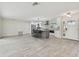 Open-concept kitchen and living area featuring tile floors, updated appliances, and a large island at 94 Nicholas Dr, Dunedin, FL 34698