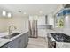 Bright kitchen featuring stainless steel appliances, a gas range, and updated cabinetry at 94 Nicholas Dr, Dunedin, FL 34698