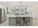 Open kitchen featuring a large island, stainless steel appliances, and bright natural light at 94 Nicholas Dr, Dunedin, FL 34698