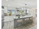 Spacious kitchen with a center island, barstool seating, and modern lighting fixtures at 94 Nicholas Dr, Dunedin, FL 34698