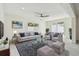 Staged living room area with a comfy sofa and backyard view at 94 Nicholas Dr, Dunedin, FL 34698
