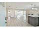 Bright, open-concept living room with tile floors, stylish lighting, and seamless flow into the kitchen at 94 Nicholas Dr, Dunedin, FL 34698