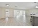 Spacious living room with tile flooring, recessed lighting, and a view into the adjacent living spaces at 94 Nicholas Dr, Dunedin, FL 34698