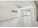 Bright, spacious living area with sliding door, tile floors and backyard access at 94 Nicholas Dr, Dunedin, FL 34698
