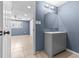 Bathroom with grey vanity and view into the bedroom at 9915 Aetna Ln, Port Richey, FL 34668