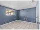 Cozy bedroom showcasing tile floors, fresh paint, and natural light at 9915 Aetna Ln, Port Richey, FL 34668