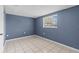 Bright bedroom with tile flooring and window with natural light at 9915 Aetna Ln, Port Richey, FL 34668