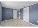 Empty bedroom with tile floors and a view into other rooms at 9915 Aetna Ln, Port Richey, FL 34668