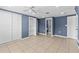 Bedroom with tile flooring, closet, ceiling fan and access to bathroom at 9915 Aetna Ln, Port Richey, FL 34668