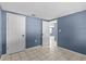 Spacious bedroom features tile flooring, a closet, and access to other rooms at 9915 Aetna Ln, Port Richey, FL 34668