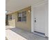 Close-up of front door with white trim, hardware, and adjacent window at 9915 Aetna Ln, Port Richey, FL 34668