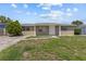 Charming single-story home featuring a tidy front yard and neutral-toned exterior at 9915 Aetna Ln, Port Richey, FL 34668