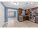 Stylish kitchen boasts stainless steel appliances and dark wood cabinetry at 9915 Aetna Ln, Port Richey, FL 34668
