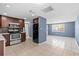 Open kitchen with stainless steel appliances, wood cabinets, and tile floors at 9915 Aetna Ln, Port Richey, FL 34668