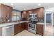 This kitchen features stainless steel appliances and wood cabinetry at 9915 Aetna Ln, Port Richey, FL 34668