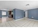 Open-concept living space with tile floors that connects living room to kitchen at 9915 Aetna Ln, Port Richey, FL 34668