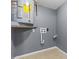 Utility room features a gray water heater and modern neutral color scheme at 9915 Aetna Ln, Port Richey, FL 34668