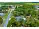 Aerial view showcasing a home with a pool surrounded by mature trees and the scenic landscape of the neighborhood at 10197 Meadow Wren Ave, Weeki Wachee, FL 34613