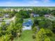 Aerial view showcases a beautiful home, pool, and mature trees with a backdrop of scenic landscape at 10197 Meadow Wren Ave, Weeki Wachee, FL 34613