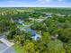 An aerial view of a single-Gathering home with a pool surrounded by lush forestry and mature tree growth at 10197 Meadow Wren Ave, Weeki Wachee, FL 34613
