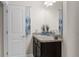 Bathroom vanity features granite countertop, modern faucet and is next to a white paneled door at 10197 Meadow Wren Ave, Weeki Wachee, FL 34613