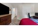 This bedroom shows a large dresser and office desk, leading to two open doorways at 10197 Meadow Wren Ave, Weeki Wachee, FL 34613