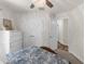 Bright bedroom with hardwood floors, a decorative ceiling fan, and lots of closet space for ample storage at 10197 Meadow Wren Ave, Weeki Wachee, FL 34613