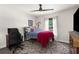 Cozy bedroom features a ceiling fan, window with curtains, and carpeted floors at 10197 Meadow Wren Ave, Weeki Wachee, FL 34613