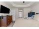 Open bedroom view towards the hall; features a TV, dresser, and neutral decor at 10197 Meadow Wren Ave, Weeki Wachee, FL 34613